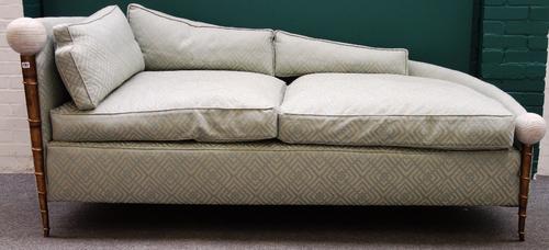 A 20th century copper and bronze framed sofa with carved spherical stone finials on faux bamboo supports, 224cm wide.