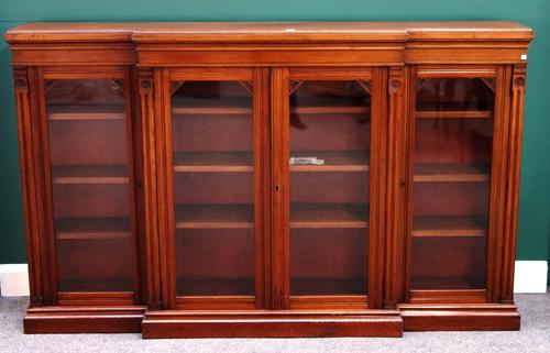 A Victorian walnut breakfront glazed four door bookcase on plinth base, 200cm wide x 124cm high.