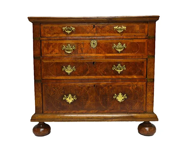 An early 18th century and later oak and walnut chest of four long graduated drawers on bun feet, 96cm wide.   Illustrated