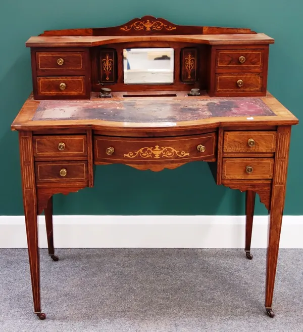 A late Victorian marquetry inlaid writing desk, with fitted superstructure over a bow five drawer frieze, on tapering square supports, 90cm wide.