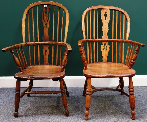 An early 19th century ash and elm Windsor chair with pierced splat and turned supports, together with another similar. (2)