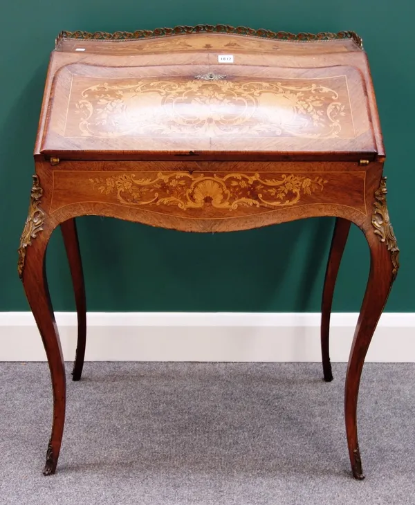 A late 19th century French gilt metal mounted marquetry inlaid rosewood bureau de dame, of bombe serpentine outline with fitted and welled interior, o
