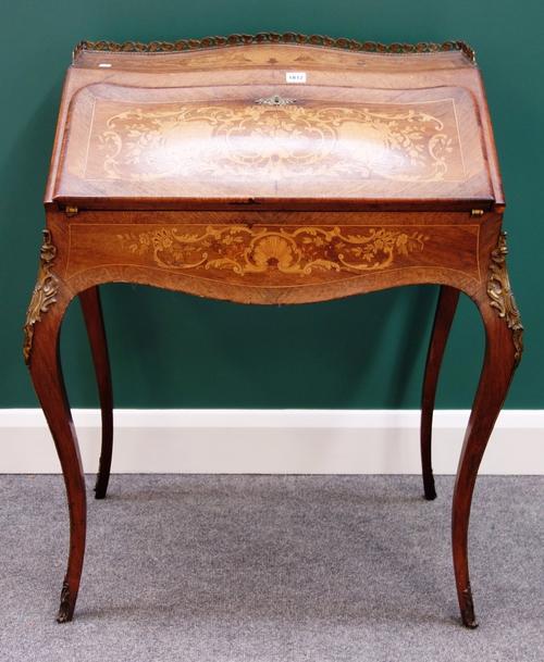 A late 19th century French gilt metal mounted marquetry inlaid rosewood bureau de dame, of bombe serpentine outline with fitted and welled interior, o