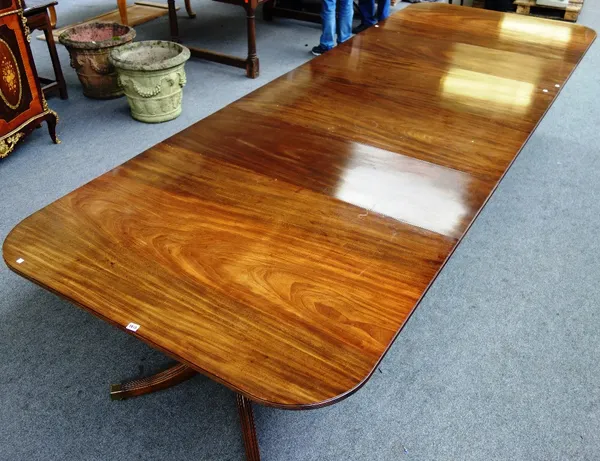 A Regency style mahogany triple pillar dining table on twelve downswept supports, two extra leaves, 134cm wide x 290cm long x 380cm fully extended.