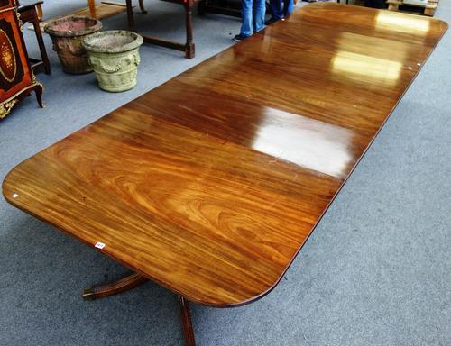A Regency style mahogany triple pillar dining table on twelve downswept supports, two extra leaves, 134cm wide x 290cm long x 380cm fully extended.