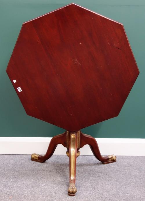 A 19th century Russian gilt metal mounted mahogany occasional table, the snap hexagonal top on tripod base and paw feet, 90cm wide.
