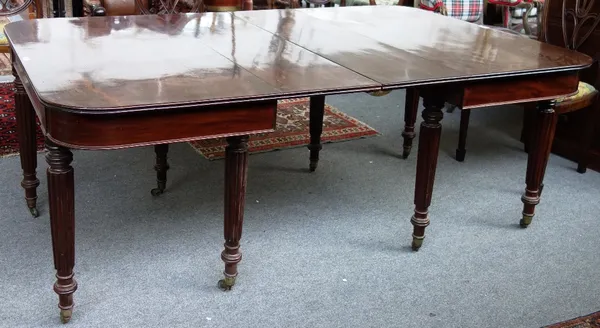 A George III mahogany extending dining table, with pair of single drop sided rounded rectangular ends each on four tapering reeded supports, to includ