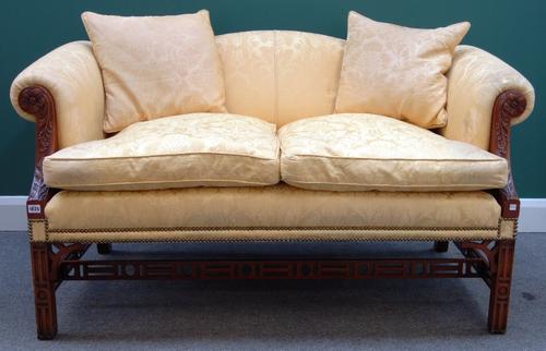 After the St Giles Suite; a 20th century, mahogany framed three piece suite to comprise a humpback sofa and pair of Gainsborough design open armchairs