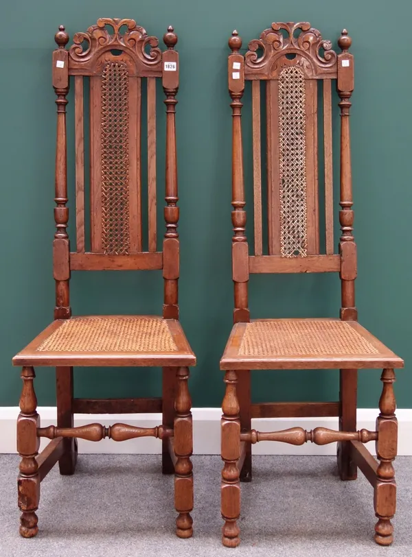 A pair of 17th century style beech and oak high back side chairs with turned supports.