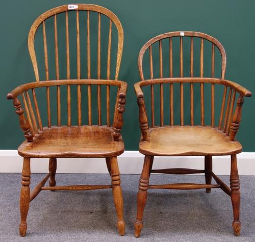 An early 19th century ash and elm bow back Windsor chair on turned supports, together with another similar. (2)