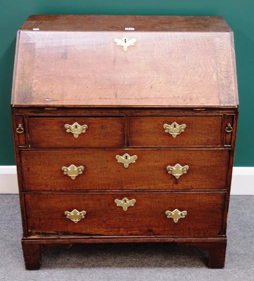 A small 18th century oak bureau, the fitted interior over two short and two long drawers, on bracket feet, 76cm wide x 89cm high.