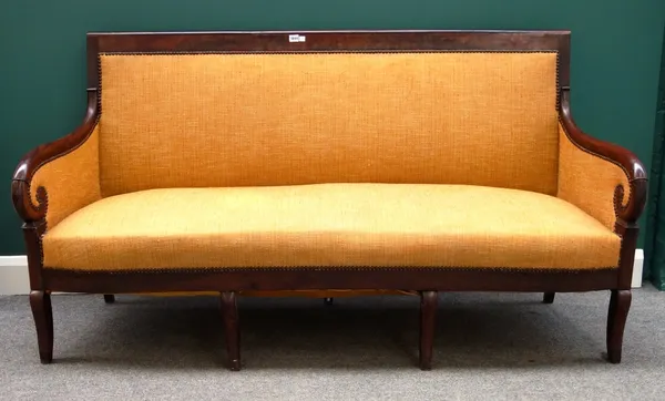 An early 19th century French mahogany framed sofa with bow seat on sabre supports, 180cm wide.