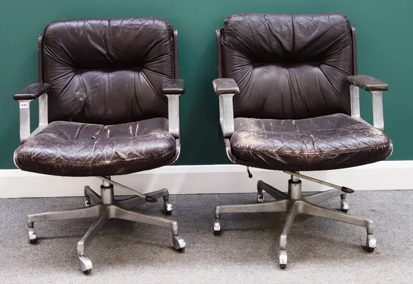 A pair of mid 20th century polished steel and rouge leather office swivel chairs, each on six point bases.