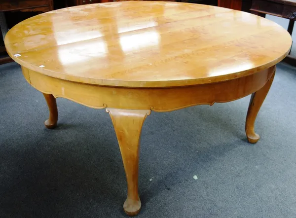 A 19th century French satin birch circular extending dining table on four cabriole supports, to include five extra leaves, 165cm wide x 460cm fully ex