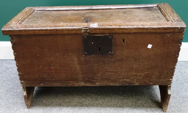 A 17th century oak plank coffer with chip work decoration, on shaped slab end supports, 79cm wide.