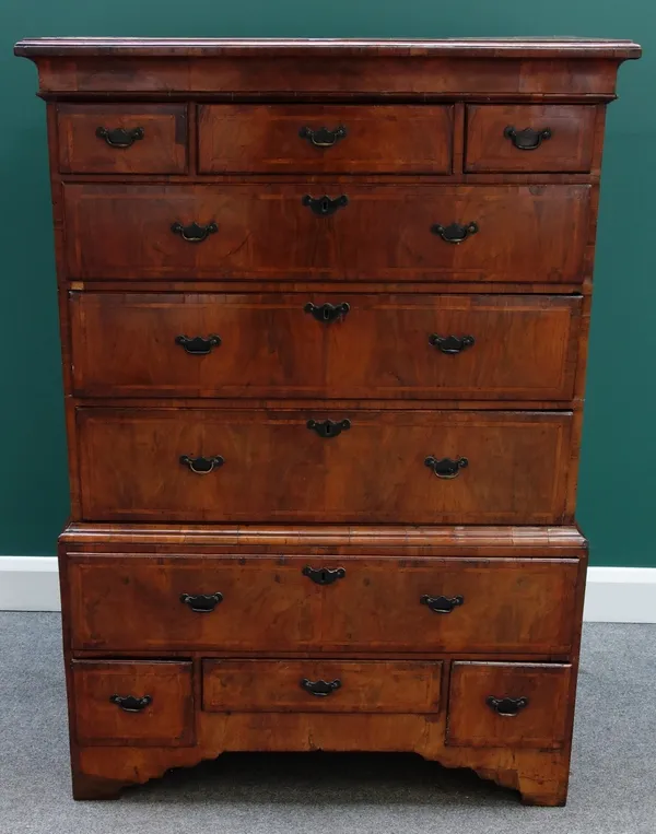 An early 18th century and later figured walnut chest on stand, the chest with three short over three long graduated drawers, the stand with one long o