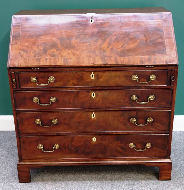 A George III mahogany bureau, the fall revealing a fitted interior, over four long graduated drawers, on bracket feet, 103cm wide.