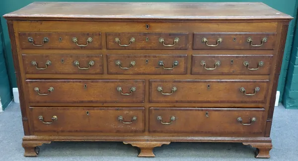 A mid 18th century mahogany banded oak mule chest, the lift top over two rows of three dummy drawers, above four true drawers, flanked by fluted corne