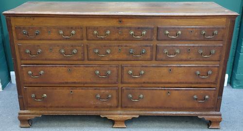 A mid 18th century mahogany banded oak mule chest, the lift top over two rows of three dummy drawers, above four true drawers, flanked by fluted corne