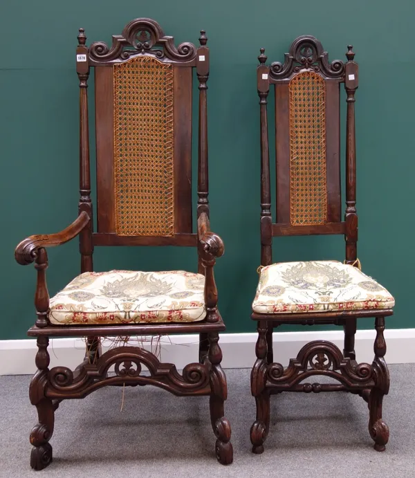 A set of seven 17th century style stained beech and oak high back dining chairs with carved arch stretcher including one carver together with similar