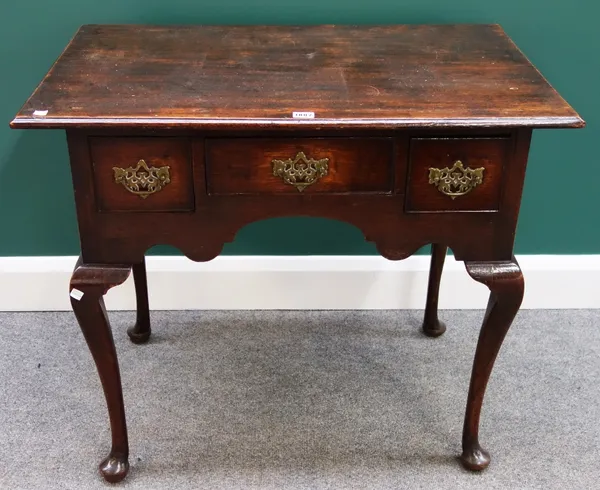 An 18th century oak low boy, with three frieze drawers on cabriole supports, 85cm wide.