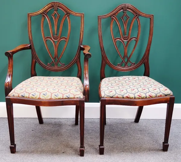 A set of six 18th century style shield back dining chairs, with serpentine seats on tapering square supports, to include a single carver. (6)