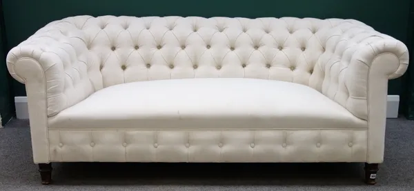 A late 19th century cream button upholstered Chesterfield sofa on turned mahogany supports, 184cm wide.