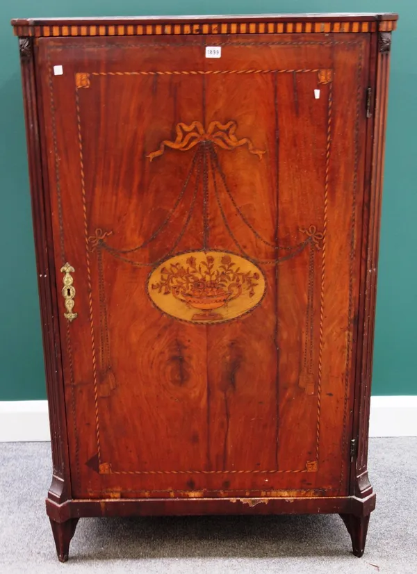 An early 19th century Dutch marquetry inlaid mahogany single door cupboard, on tapering square supports, 86cm wide.