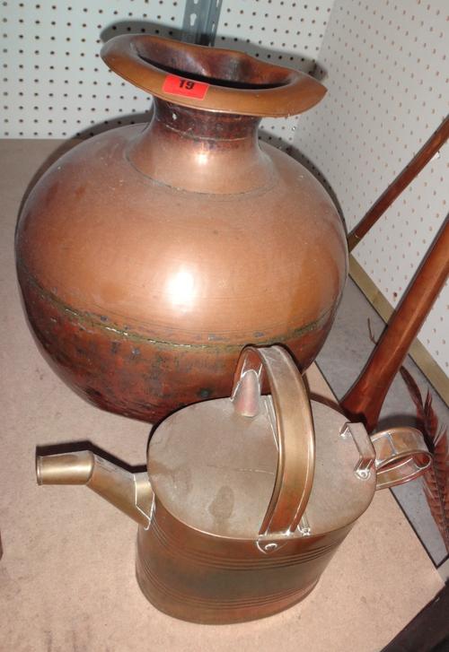 A copper vase and a brass watering can (2).