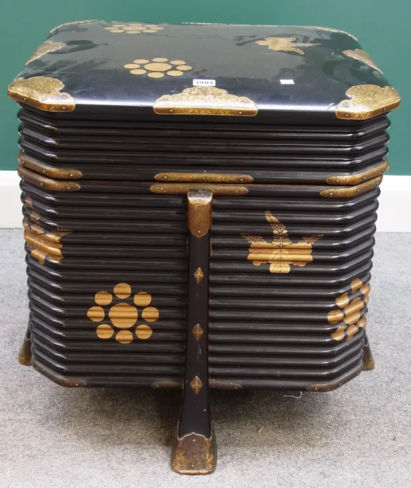 A 19th century Japanese black and gold lacquer karabitsu/picnic box, of canted ribbed square form, on flared square supports, 67cm wide.