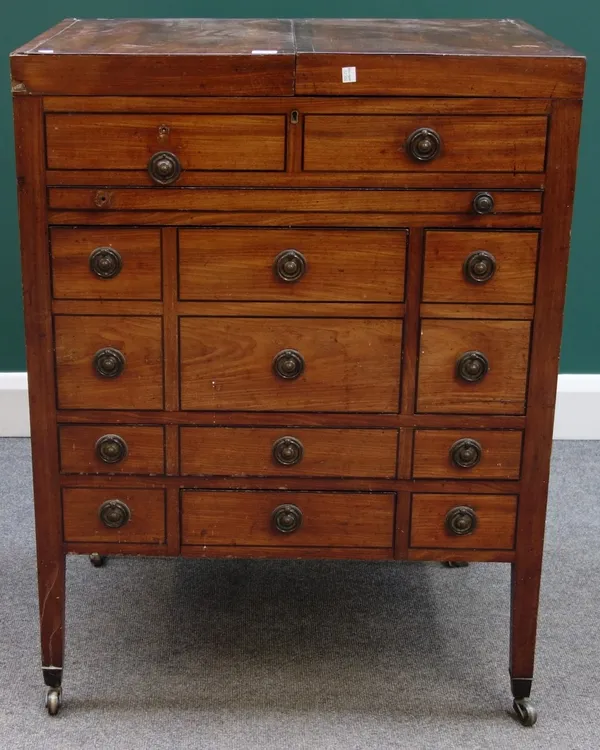 An early 19th century mahogany lift top wash stand, with fitted and mirrored interior over an arrangement of four various drawers, on square supports,