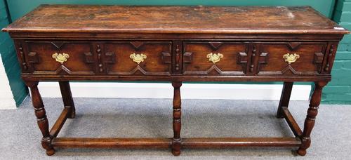 A 17th century oak dresser with pair of geometric moulded frieze drawers on turned supports, united by perimeter stretcher, 182cm wide.