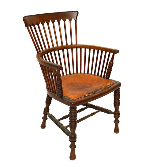 In the manor of E W Godwin, a 19th century mahogany comb back Windsor chair with solid seat and turned supports.  Illustrated