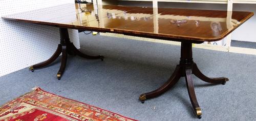 A Regency style mahogany 'D' end extending dining table, the crossbanded top on eight downswept supports, to include two extra leaves, 112cm wide x 17