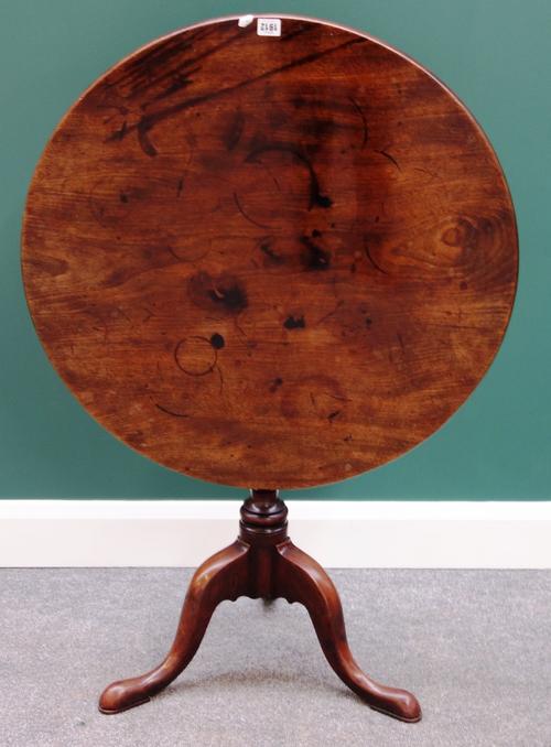 An 18th century mahogany tripod table, the one piece circular snap top on a tripod base, 75cm wide.