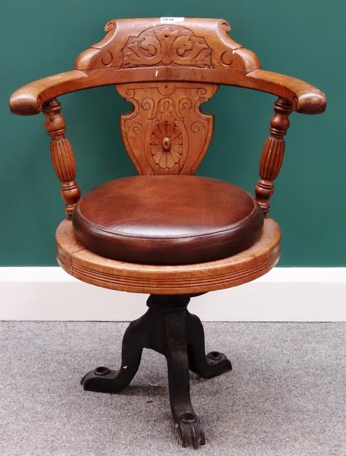 A late 19th/early 20th century carved oak open arm tub chair on three cast iron downswept supports, probably from a ship.