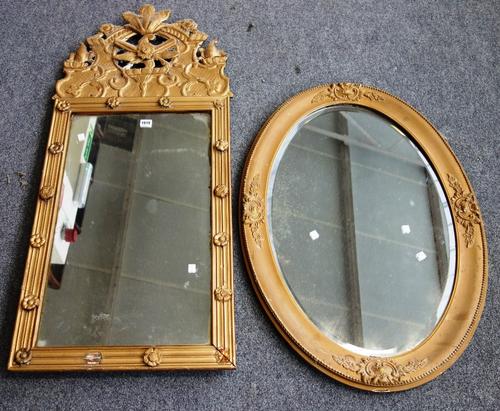A 19th century and later gilt framed rectangular wall mirror with pierced and moulded floral crest, 53cm wide x 115cm high, together with a gilt frame
