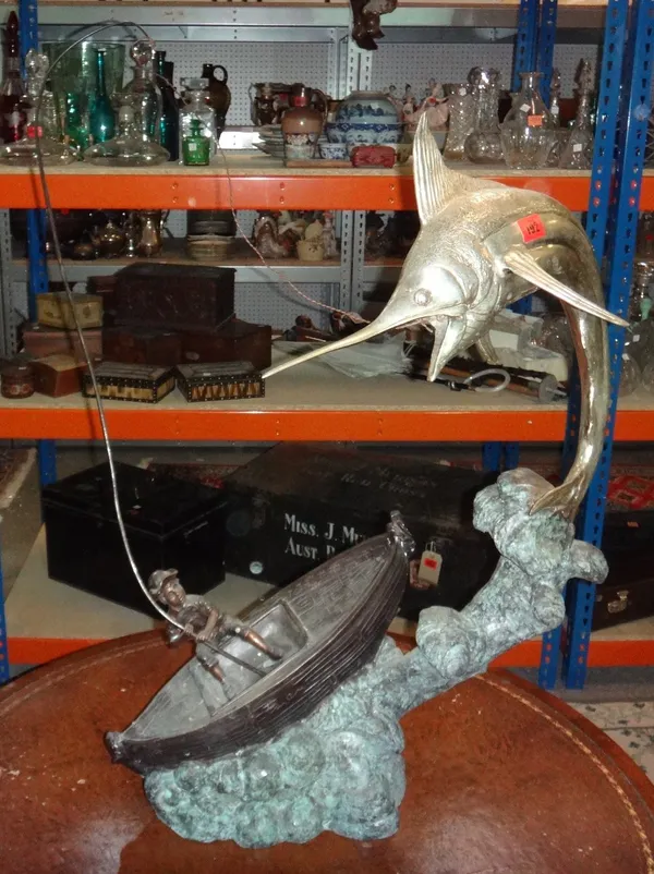 A 20th century white metal and bronze model of a fisherman and a swordfish.