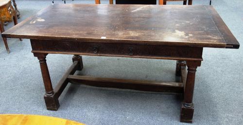 A 17th century style oak refectory table, the cleated plank top over a carved frieze with single drawer, on turned supports, 86cm x 168cm.