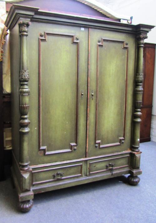A 19th century green painted Continental two door armoire, with turned columns and two drawer base, 164cm wide x 200cm high.