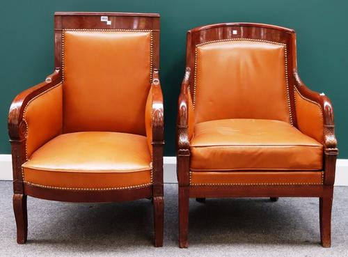 An early 19th century French mahogany framed fauteuils, the downswept arms terminating in sea serpent finials, on sabre supports, together with anothe