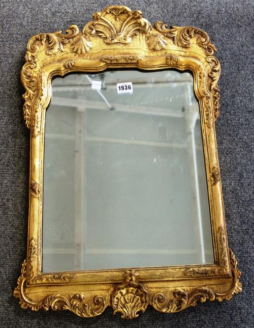 An 18th century Italian style gilt framed pier glass, with shell and scroll mounted frame about the shaped mirror plate, 42cm wide x 62cm high.