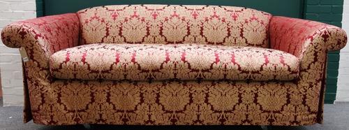 A 20th century red and golden thistle upholstered sofa on outswept arms, 245cm wide.