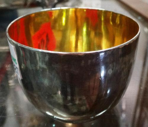 A George III silver tumbler cup of plain form, crest and motto engraved, date letter rubbed.