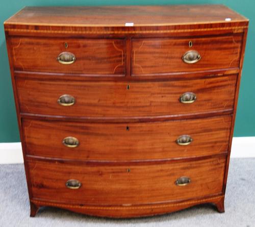 A Victorian inlaid mahogany bowfront chest of two short and three long graduated drawers, on splayed bracket feet, 105cm wide.
