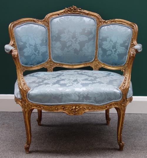 A Louis XV style gilt framed tub back open armchair of generous proportions, on slender cabriole supports.