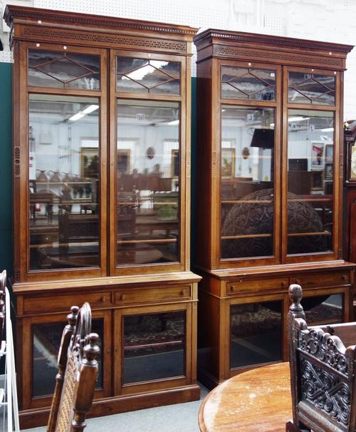 A pair of 19th century rosewood bookcase cabinets, each with semi astragal glazed upper doors over pair of drawers and further pair of glazed cupboard