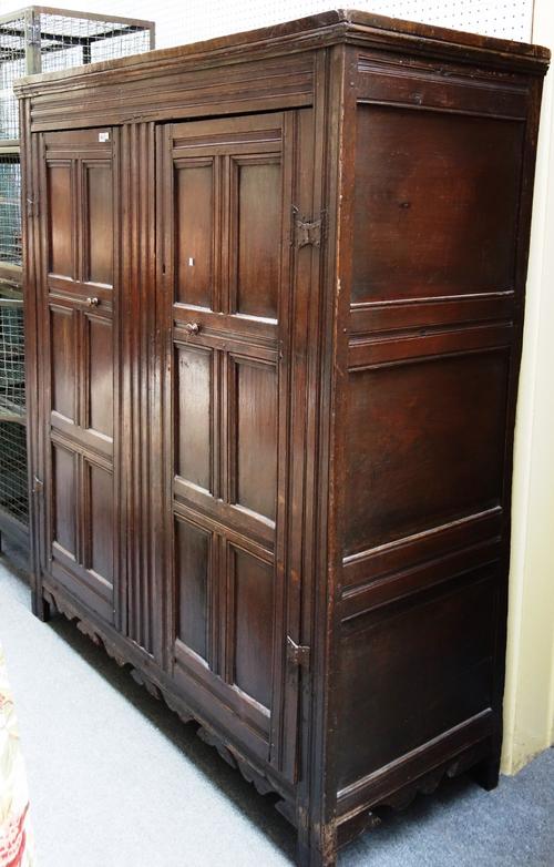 A 17th century and later oak cupboard with pair of six panel doors on stile feet, 154cm wide x 179cm high.