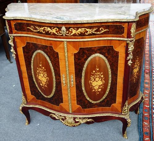 An 18th century style marquetry inlaid gilt metal mounted kingwood and figured walnut commode, the serpentine marble top over single drawer and a pair