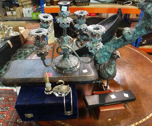 A quantity of silver plated wares, to include; a five branch candelabra, a model of a partridge, a cased Middle Eastern pot, a five piece carving set,